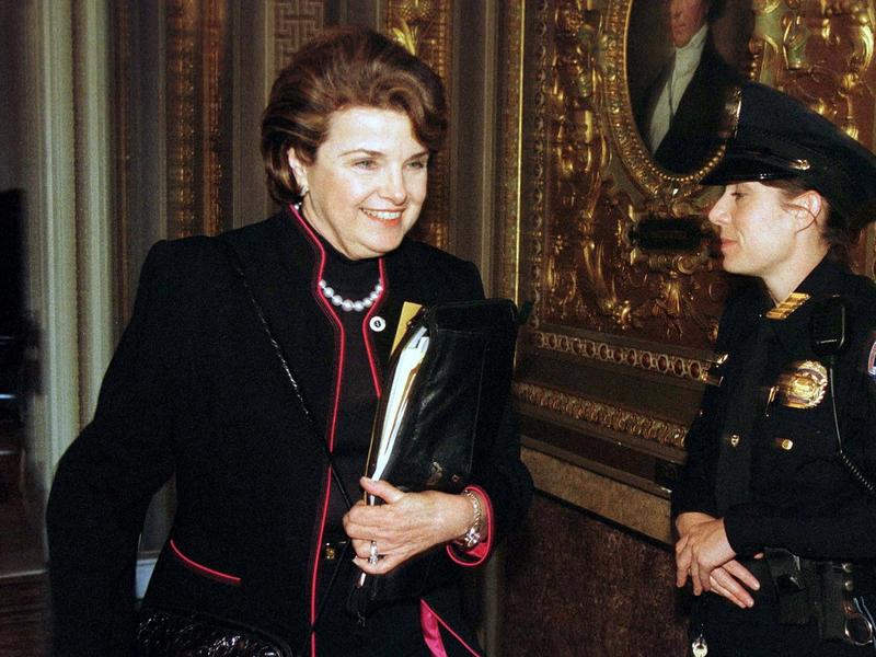 Senator Diane Feinstein (D-CA) walks past a guard at the U.S. Capitol on her way to the impeachment trial of President Clinton in Washington.