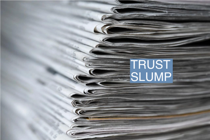 A stack of various daily newspapers lies on a table.