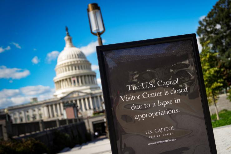 A sign, indicating that the U.S. Capitol is closed for tours, stands in front of the Capitol