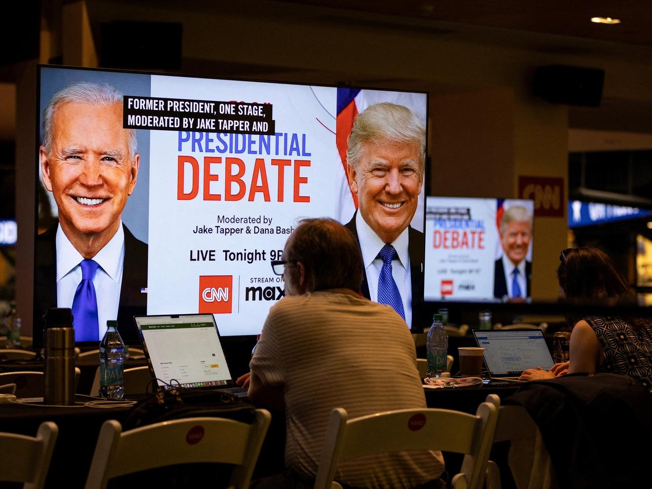 FILE PHOTO: Media crews work at the press room in the McCamish Pavilion on the Georgia Institute of Technology campus ahead of the first 2024 presidential debate between Democratic presidential candidate U.S. President Joe Biden and Republican presidential candidate former U.S. President Donald Trump in Atlanta, Georgia, U.S., June 27, 2024. REUTERS/Marco Bello/File Photo