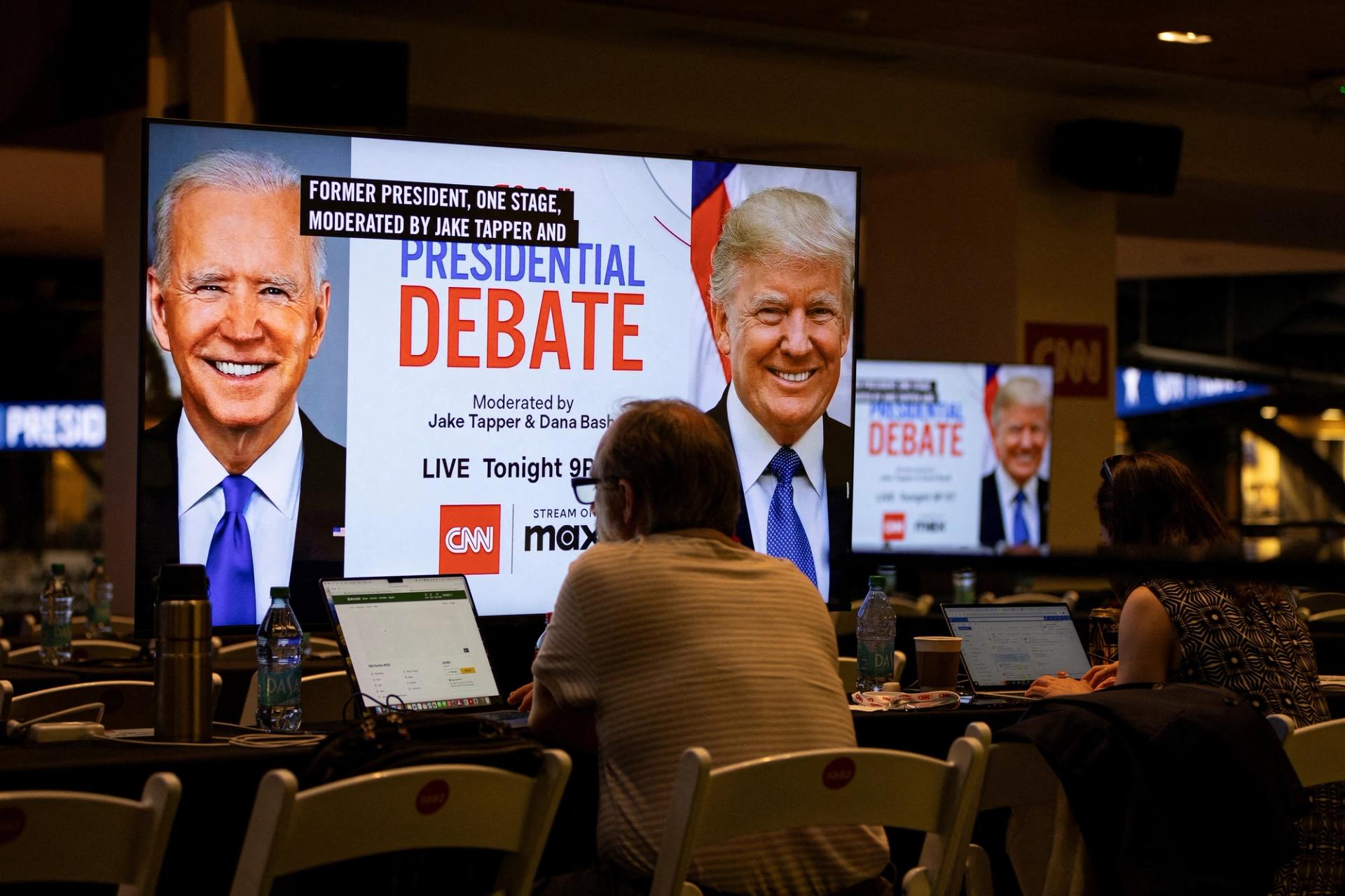 FILE PHOTO: Media crews work at the press room in the McCamish Pavilion on the Georgia Institute of Technology campus ahead of the first 2024 presidential debate between Democratic presidential candidate U.S. President Joe Biden and Republican presidential candidate former U.S. President Donald Trump in Atlanta, Georgia, U.S., June 27, 2024. REUTERS/Marco Bello/File Photo