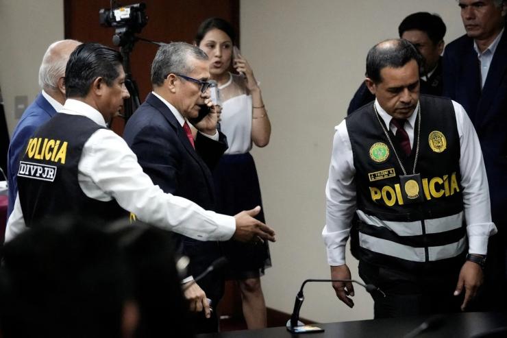 Peru’s former President Ollanto Humala is escorted by police after hearing his sentence at a court in Lima, Peru.