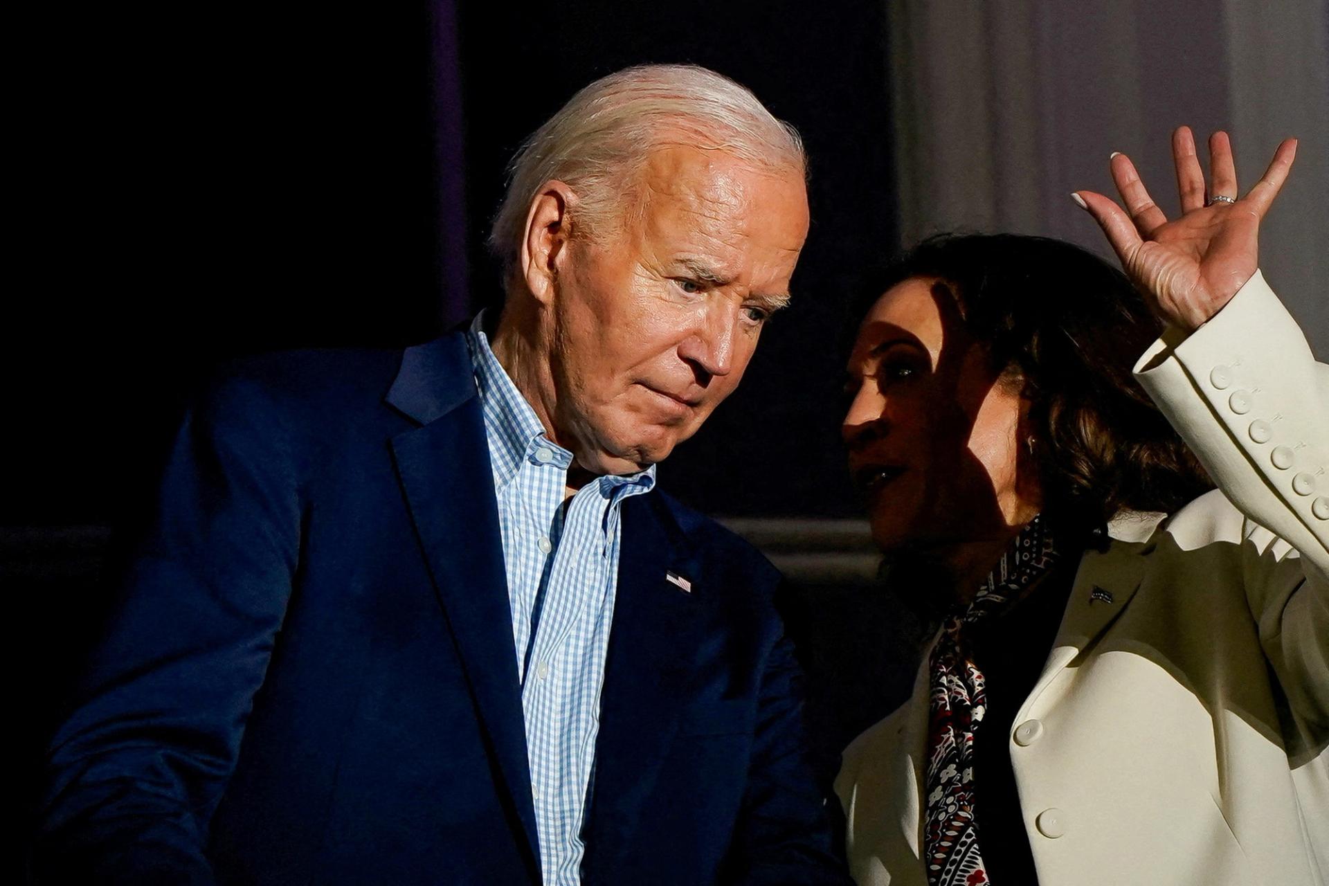 Vice President Kamala Harris speaks with President Joe Biden on a White House balcony during an Independence Day celebration in Washington, D.C., on July 4, 2024. 