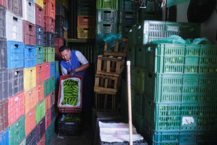 A worker prepares a shipment of bananas at the Corabastos market in Bogota.