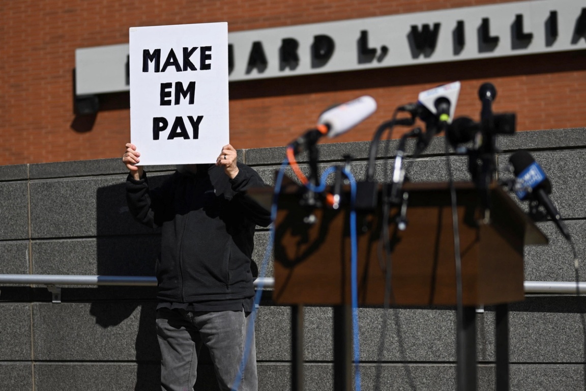A protestor demonstrates against Fox, outside the Delaware Superior Court