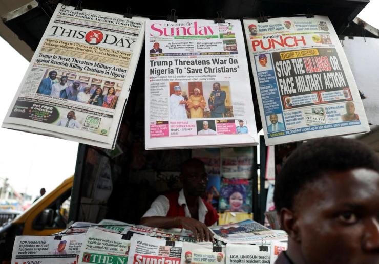 Newspapers reporting US President Donald Trump’s message to Nigeria over the alleged mistreatment of Christians hang at a newspaper stand in Lagos on Nov. 2, 2025.