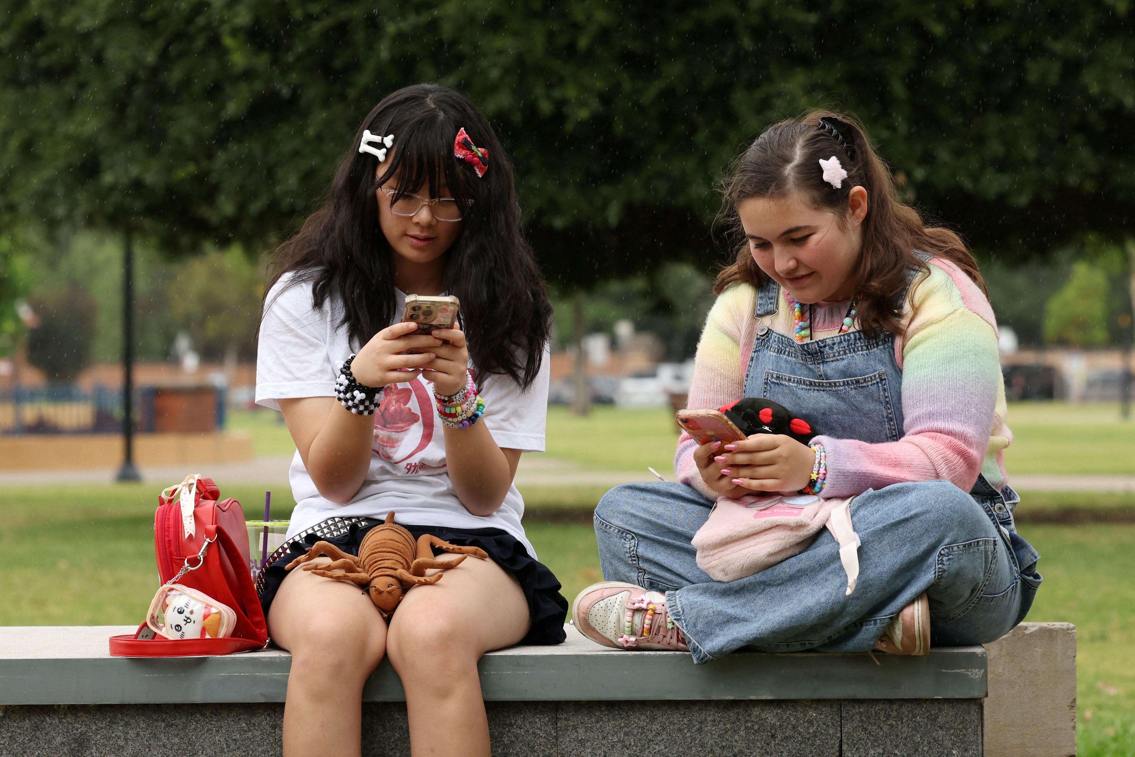 Annie Wang, 14, and Ayris Tolson, 15, pose after an interview discussing Australia’s social media ban for users under 16, which is scheduled to take effect on December 10, in Sydney, Australia