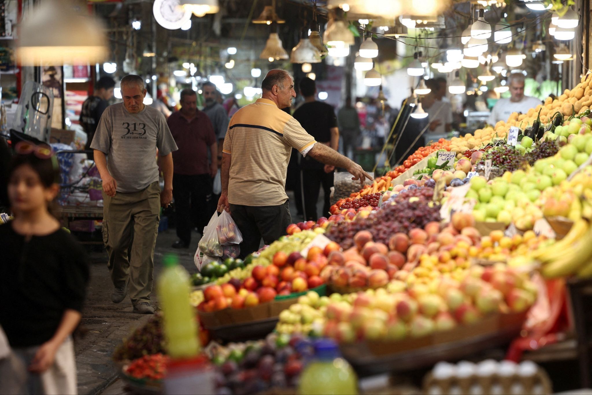 A man shops at a local market in Tehran.