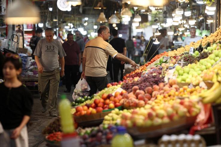 A man shops at a local market in Tehran.