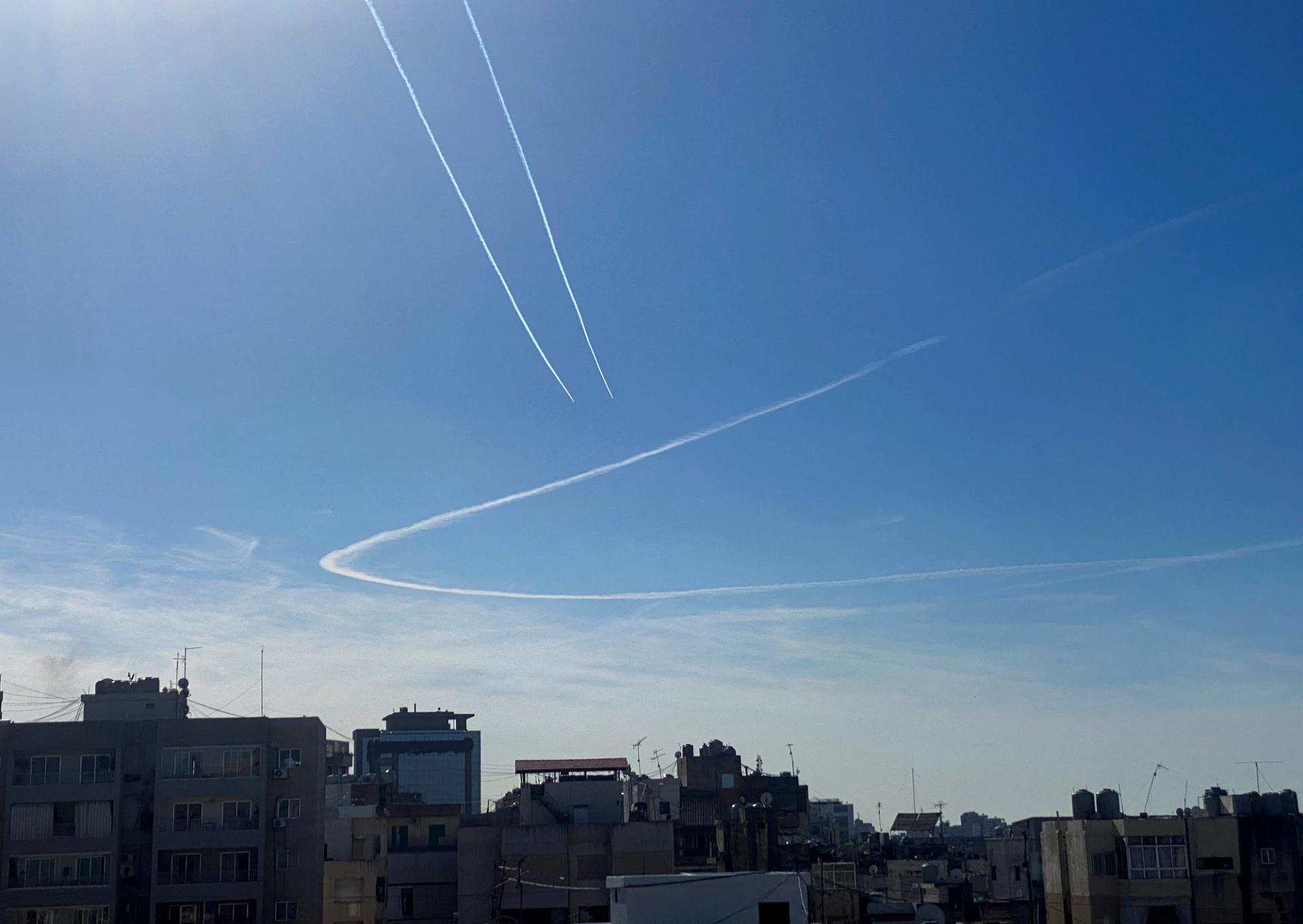 Aircraft leave vapour trails in the sky above Beirut, Lebanon December 10, 2023. REUTERS/Cynthia Karam