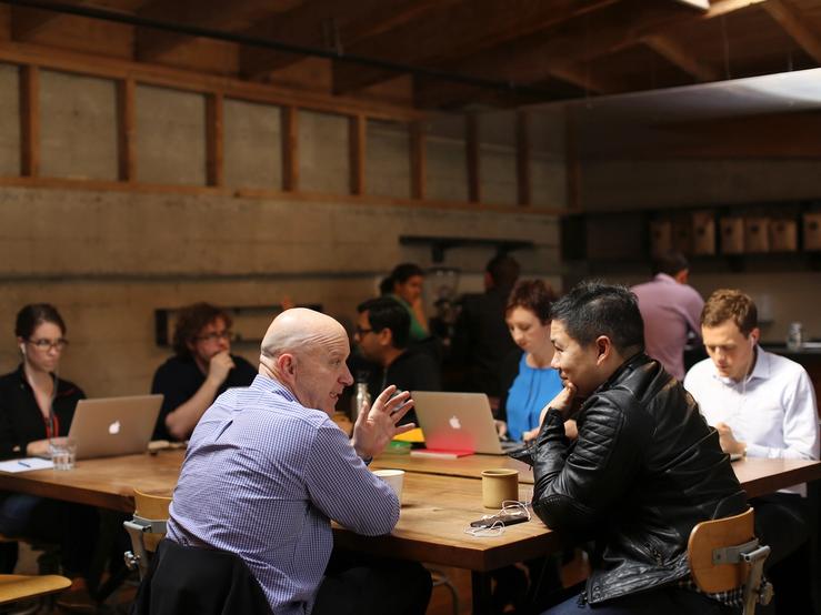 People working with laptops in a cafe.
