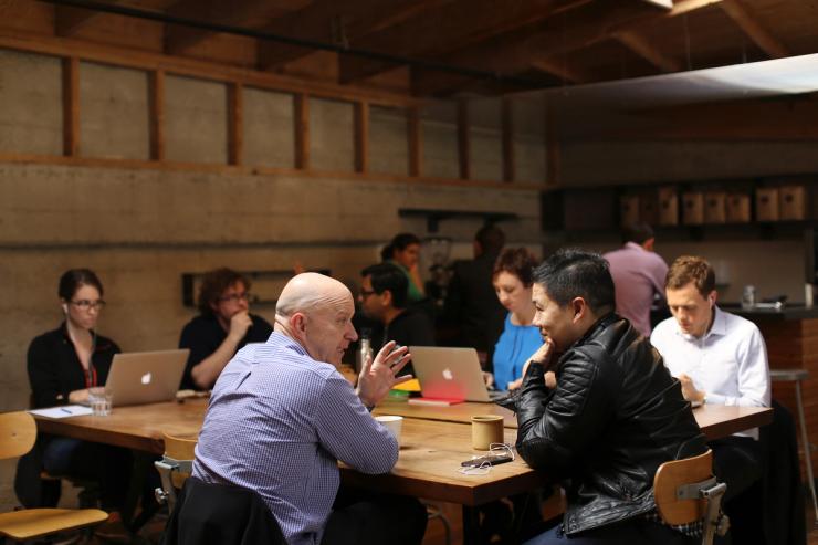 People working with laptops in a cafe.