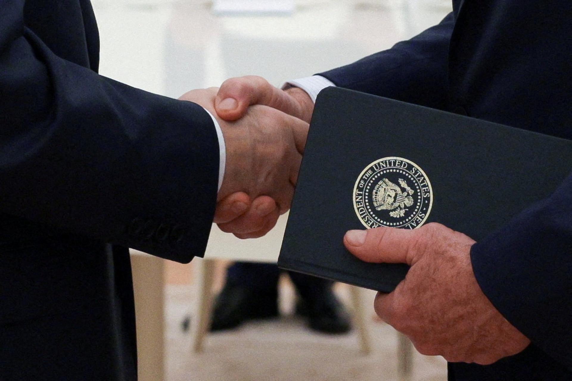 Russian President Vladimir Putin shakes hands with U.S. President Donald Trump’s envoy Steve Witkoff.