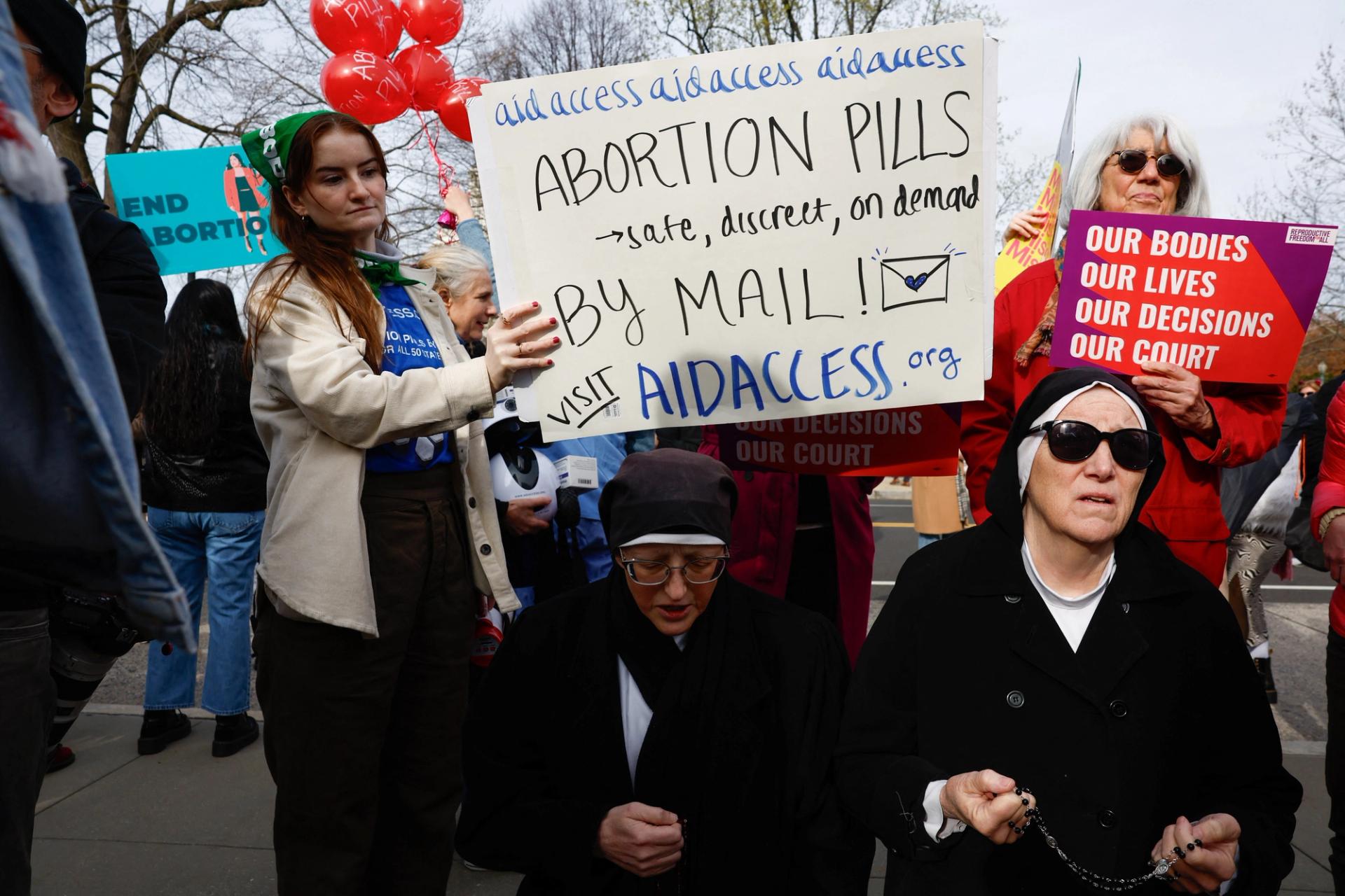 A demonstrator for abortion rights holds a placard during a protest outside the U.S. Supreme Court on March 26, 2024. 
