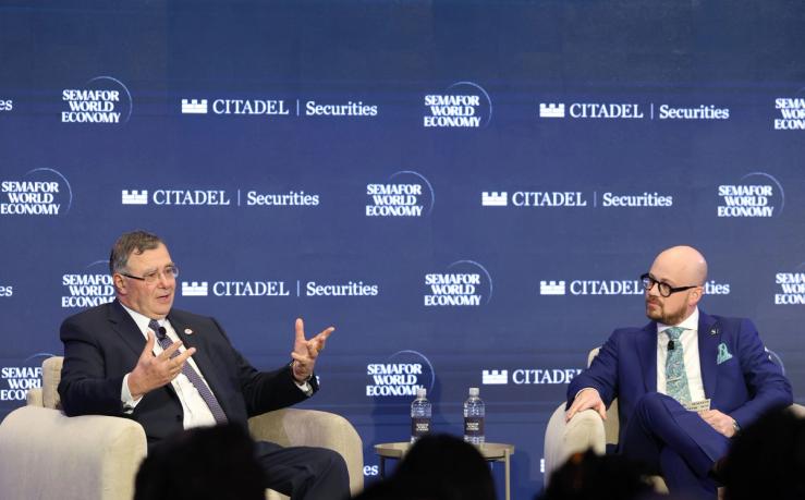 Patrick Pouyanné (L) and Semafor’s Tim McDonnell