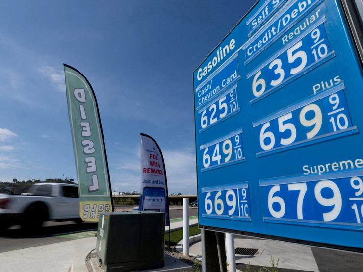 The price of gasoline is displayed at a gas station near the highway in Encinitas, California, U.S.