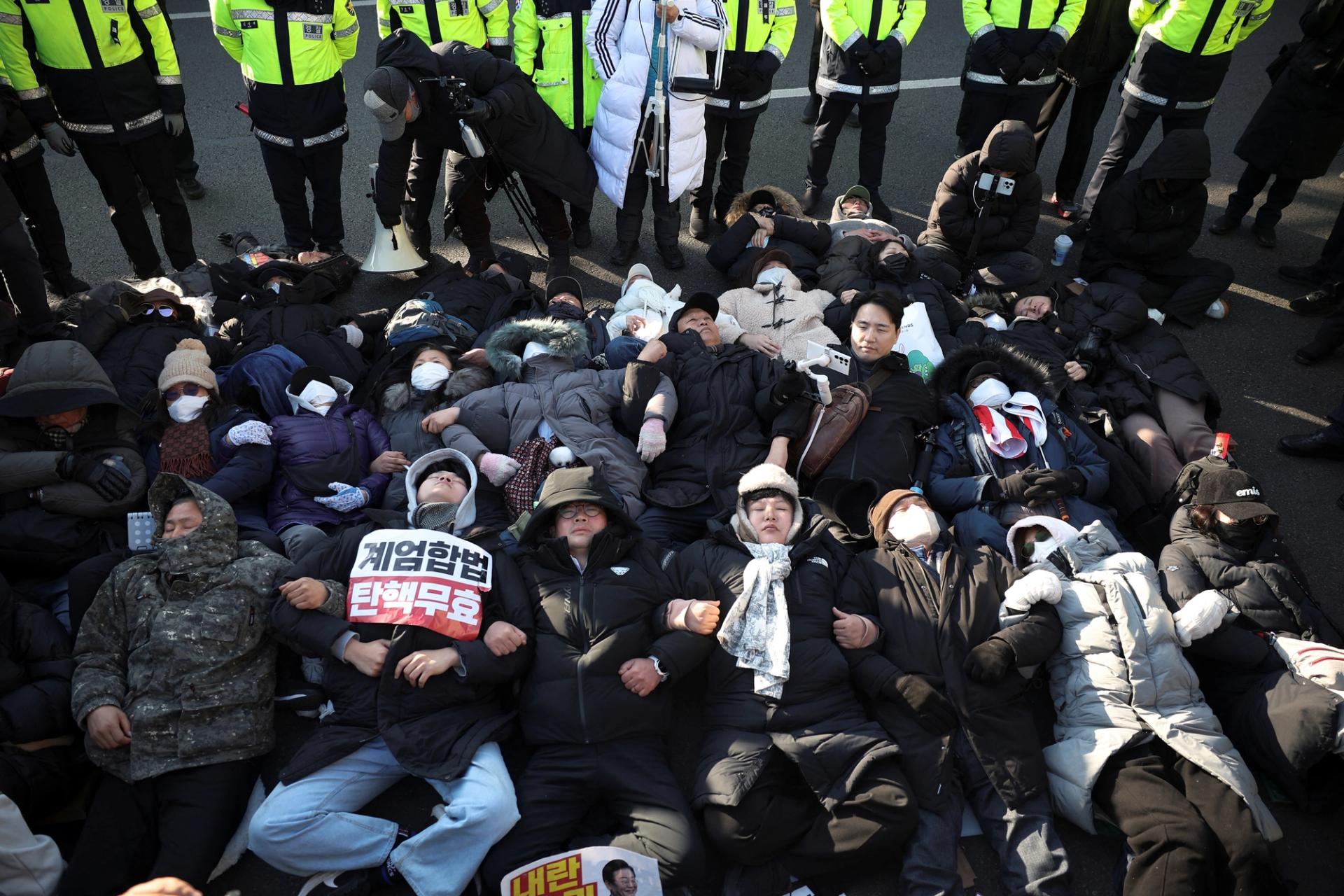 Supporters of South Korea’s impeached former President Yoon Suk Yeol gather outside his official residence.