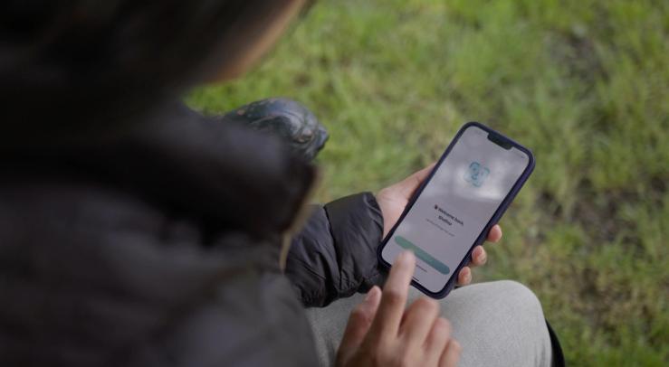 A woman using the LemFi app.
