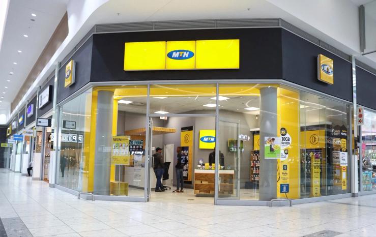 Customers are seen at an outlet of South Africa’s MTN Group at the Mall of the South in Johannesburg.