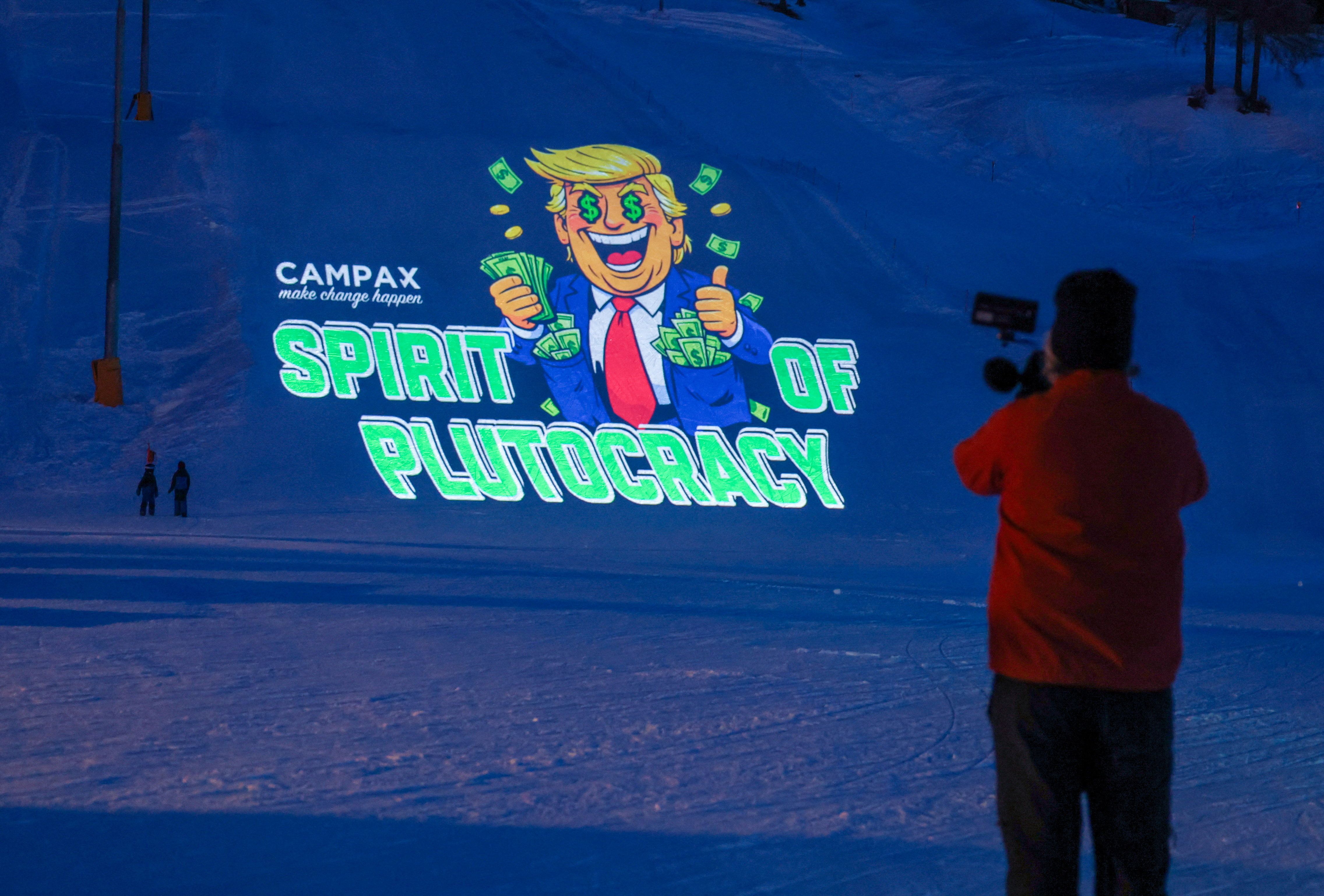 A nonprofit projects a cartoon of Trump at Davos