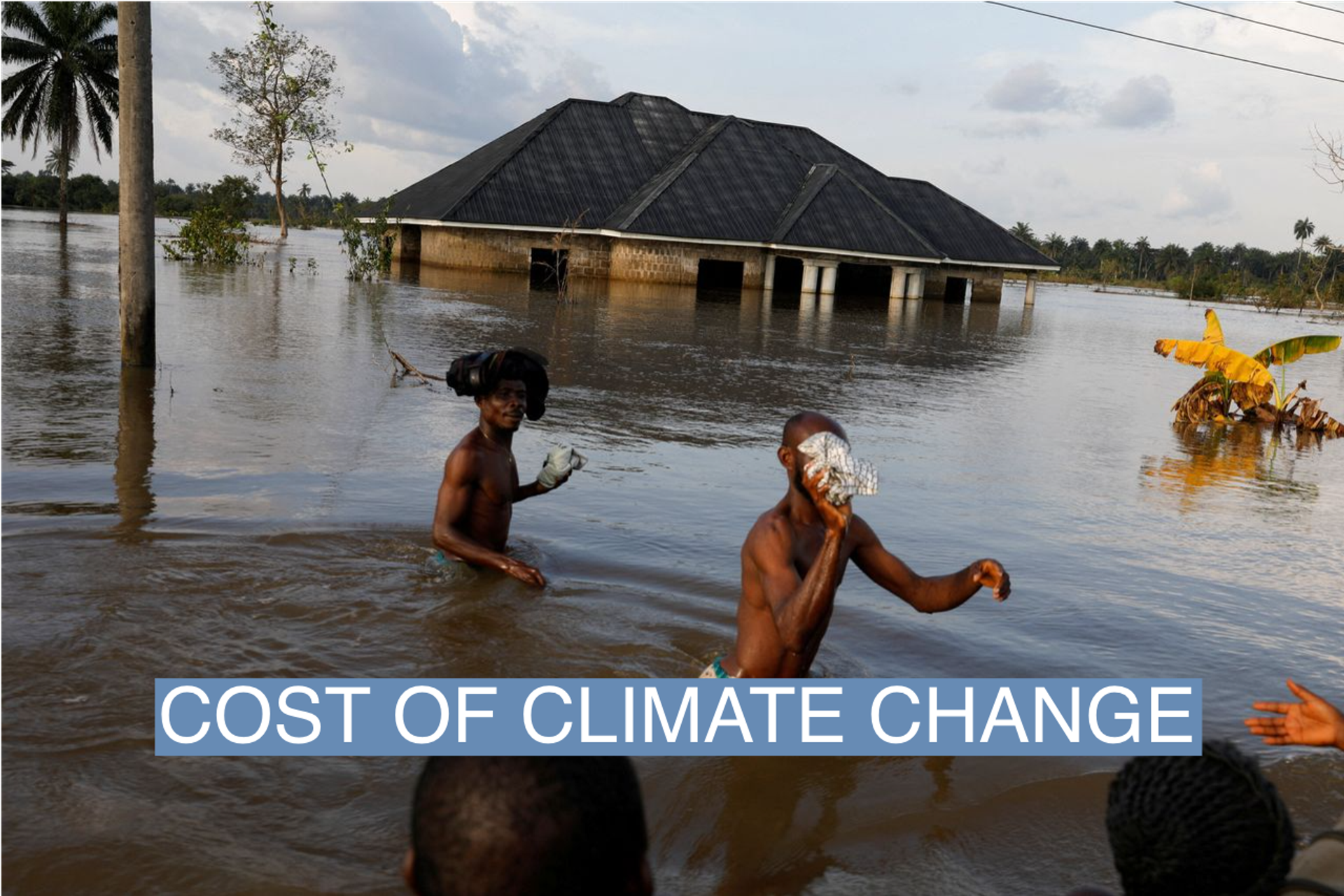 Residents wade through flood water following a massive flood in Obagi community, Rivers state, Nigeria