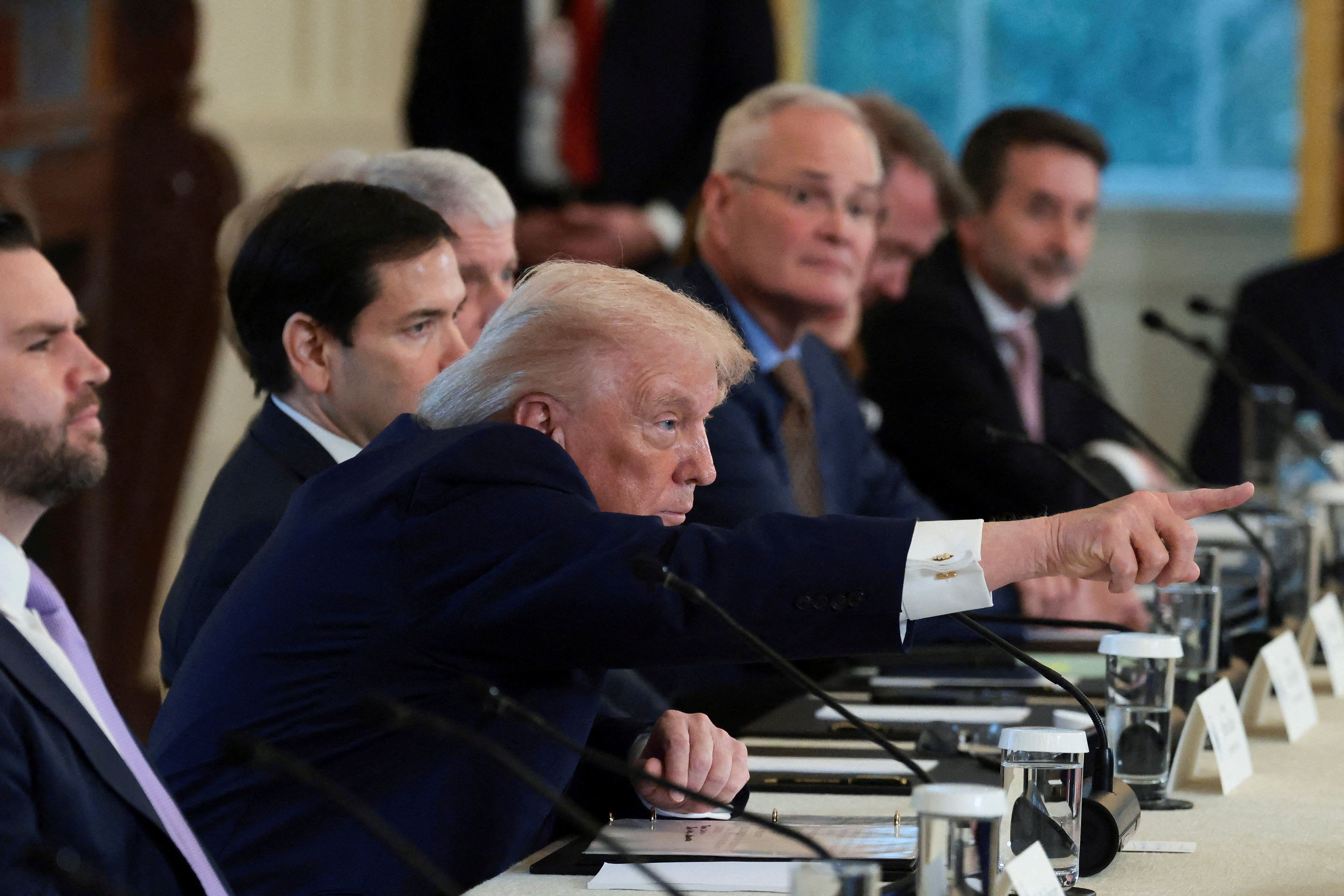 President Donald Trump points during a meeting with oil executives. 