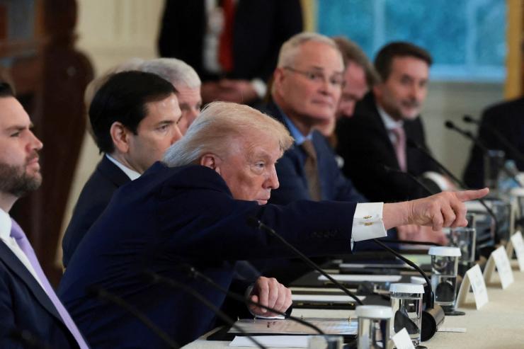 President Donald Trump points during a meeting with oil executives.