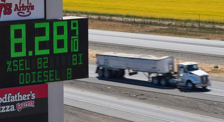 A semi drives past a sign advertising the price of diesel along Interstate 5 in Williams, California,
