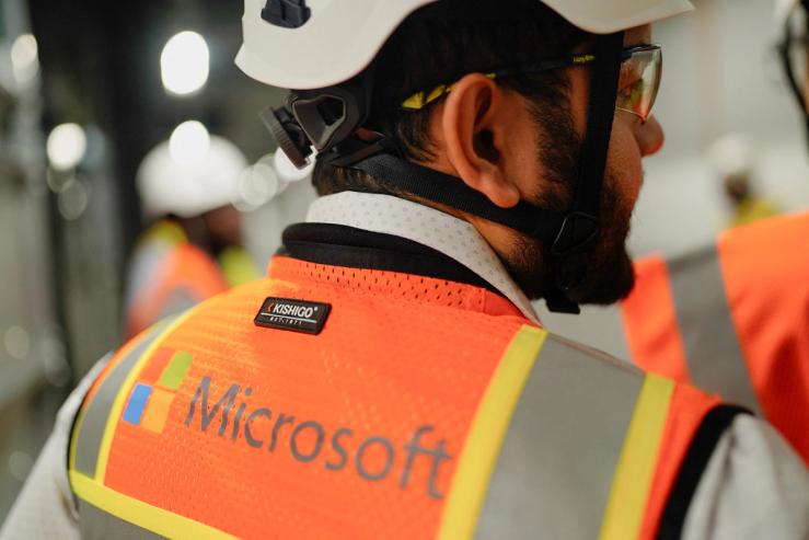 A Microsoft employee tours the Microsoft data center campus, currently under construction, after Microsoft’s Vice Chair and President Brad Smith announced a plan to spend $4 billion on an additional artificial intelligence data center, in Mount Pleasant, Wisconsin, U.S.
