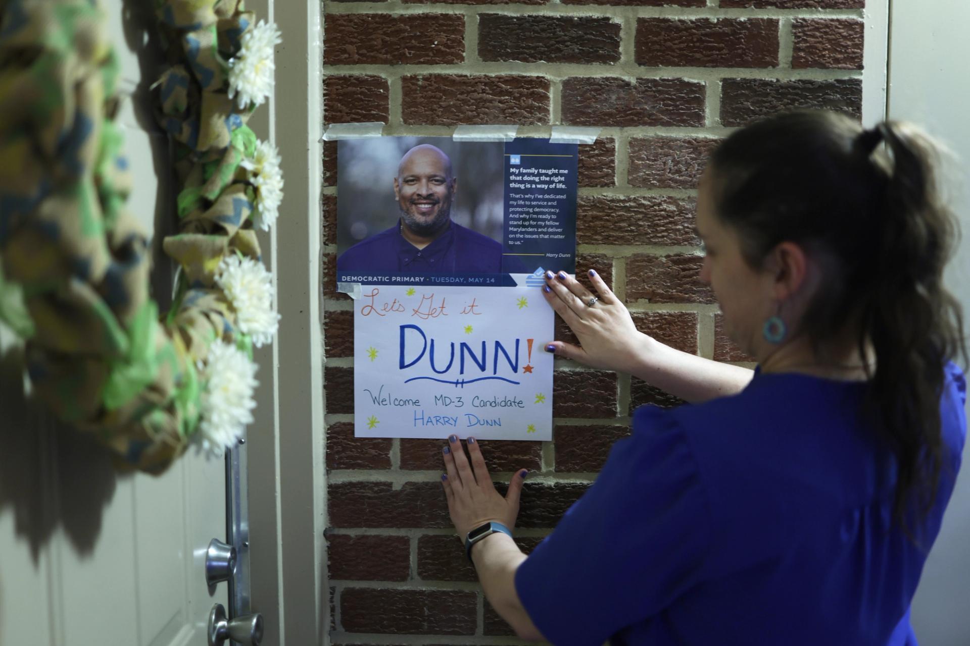 Supporter Heather Salazar puts up a welcome sign for Democratic U.S. House candidate Harry Dunn prior a house campaign party on May 7, 2024, in Savage, Md. 