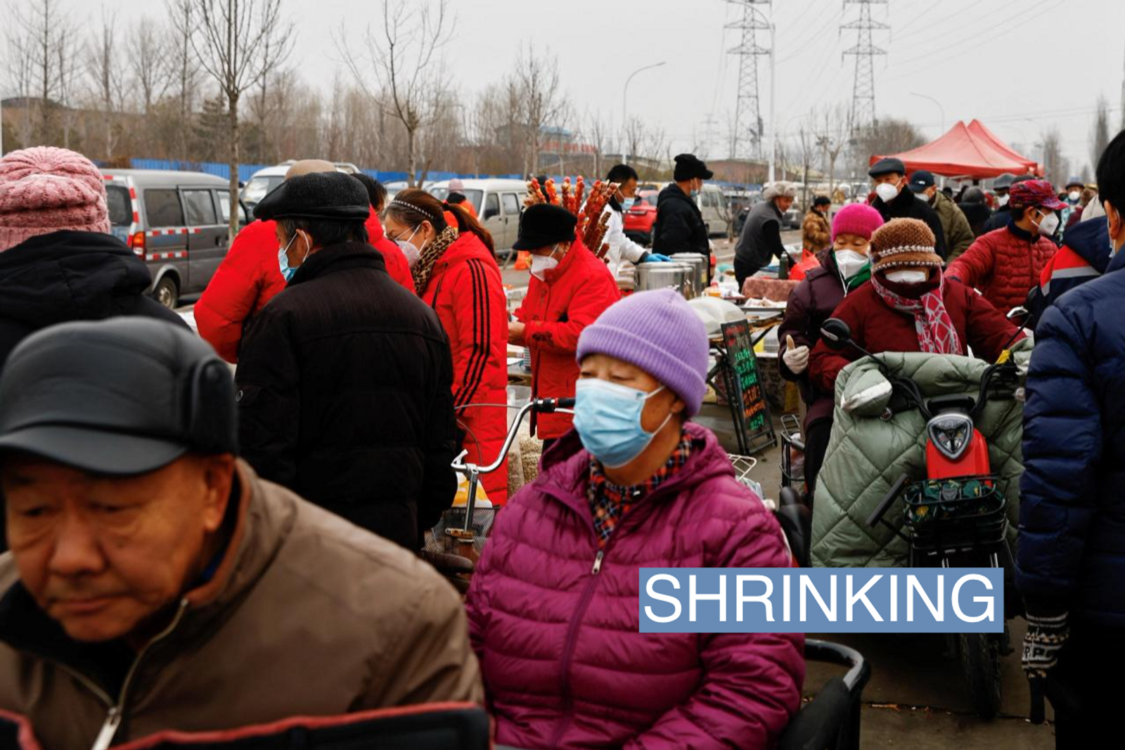 Elderly people shop ahead of the Chinese Lunar New Year at an outdoor market in Beijing, China January 13, 2023.