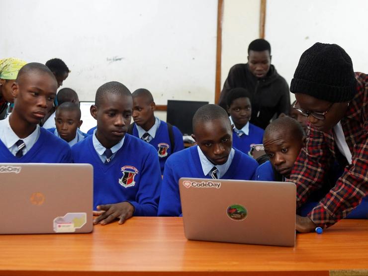 Renice Owino, founder of Code with Kids, directs pupils on a laptop during a coding lesson at the Raila Educational Centre in Kibera district of Nairobi, Kenya May 31, 2023.