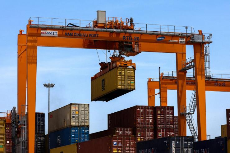 A container is loaded onto a cargo ship while docked at Hai Phong port, Vietnam.