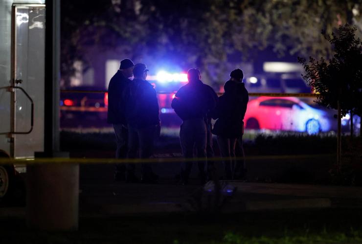 Members of the police gather at a crime scene