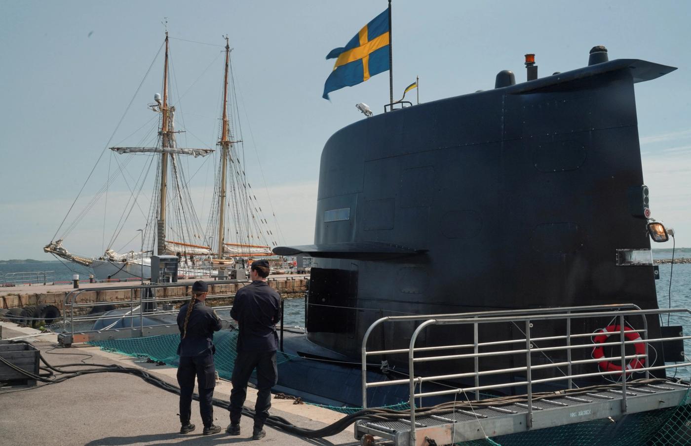 Sailors stand in front of the Swedish submarine HMS Gotland, as it lies in a port at the naval base of Karlskrona, Sweden.