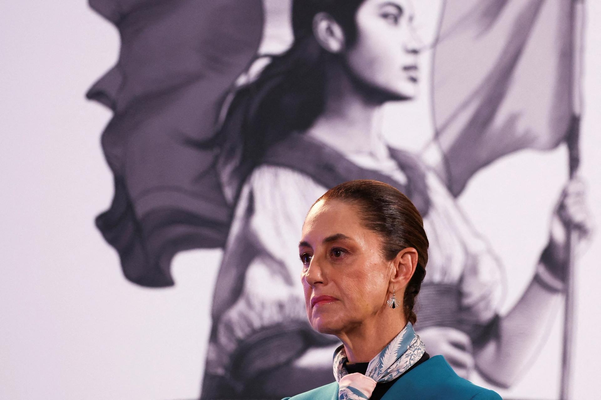 Mexican President Claudia Sheinbaum frowns at a press conference.