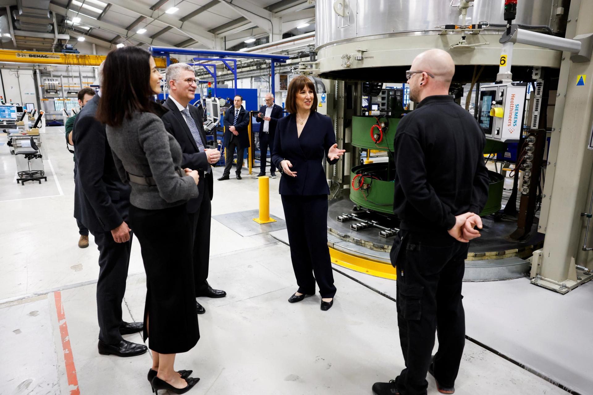 Britain’s Chancellor of the Exchequer Rachel Reeves speaks with a Siemens’ employee in Eynsham, Britain. 