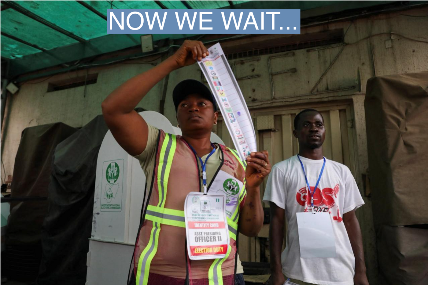 A poll worker holds up a ballot paper during the counting process of Nigeria's presidential election, at a polling unit in Awka, Anambra state, Nigeria February 25, 2023.