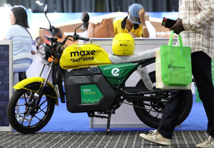 A person walks past an electric bike during an electric autos exhibition in Lagos.