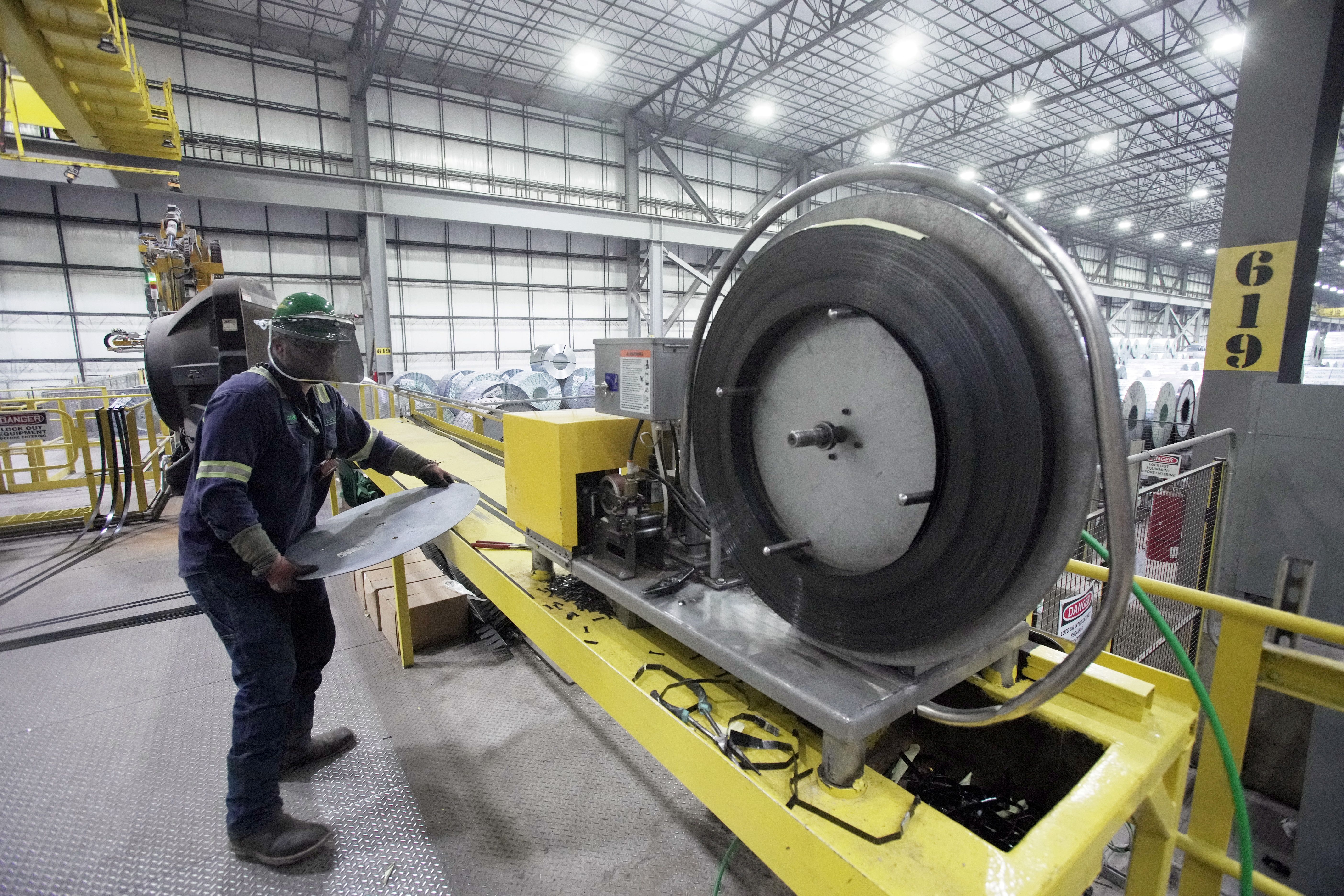 An employee works inside a Nucor steel factory.