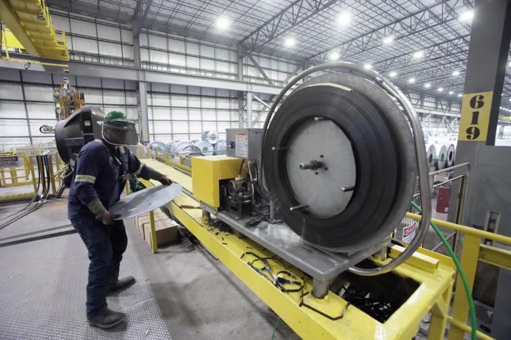 An employee works inside a Nucor steel factory.