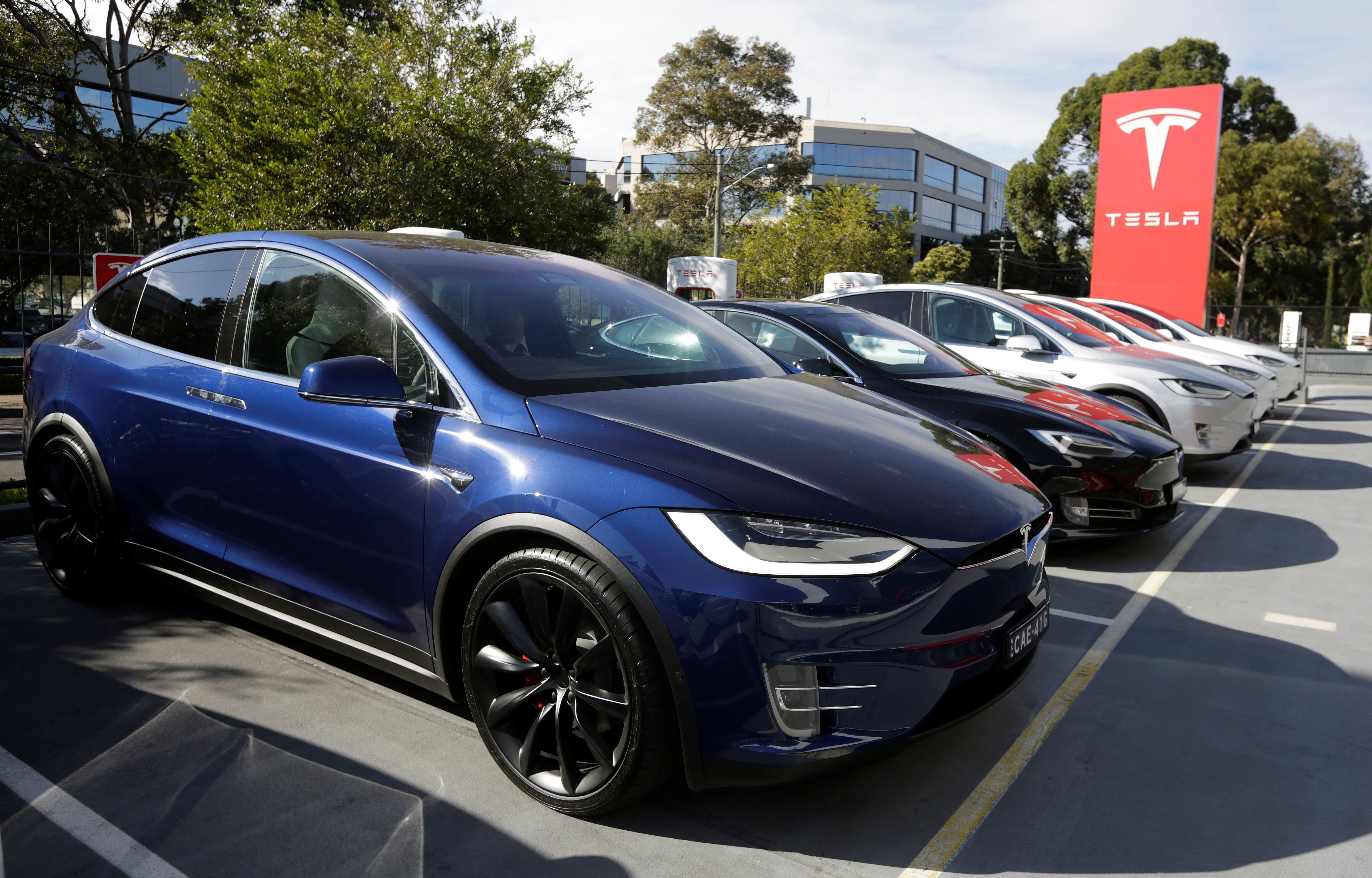 A Tesla Model X car (front) and Model S (2nd L) are photographed at a Tesla electric car dealership in Sydney, Australia