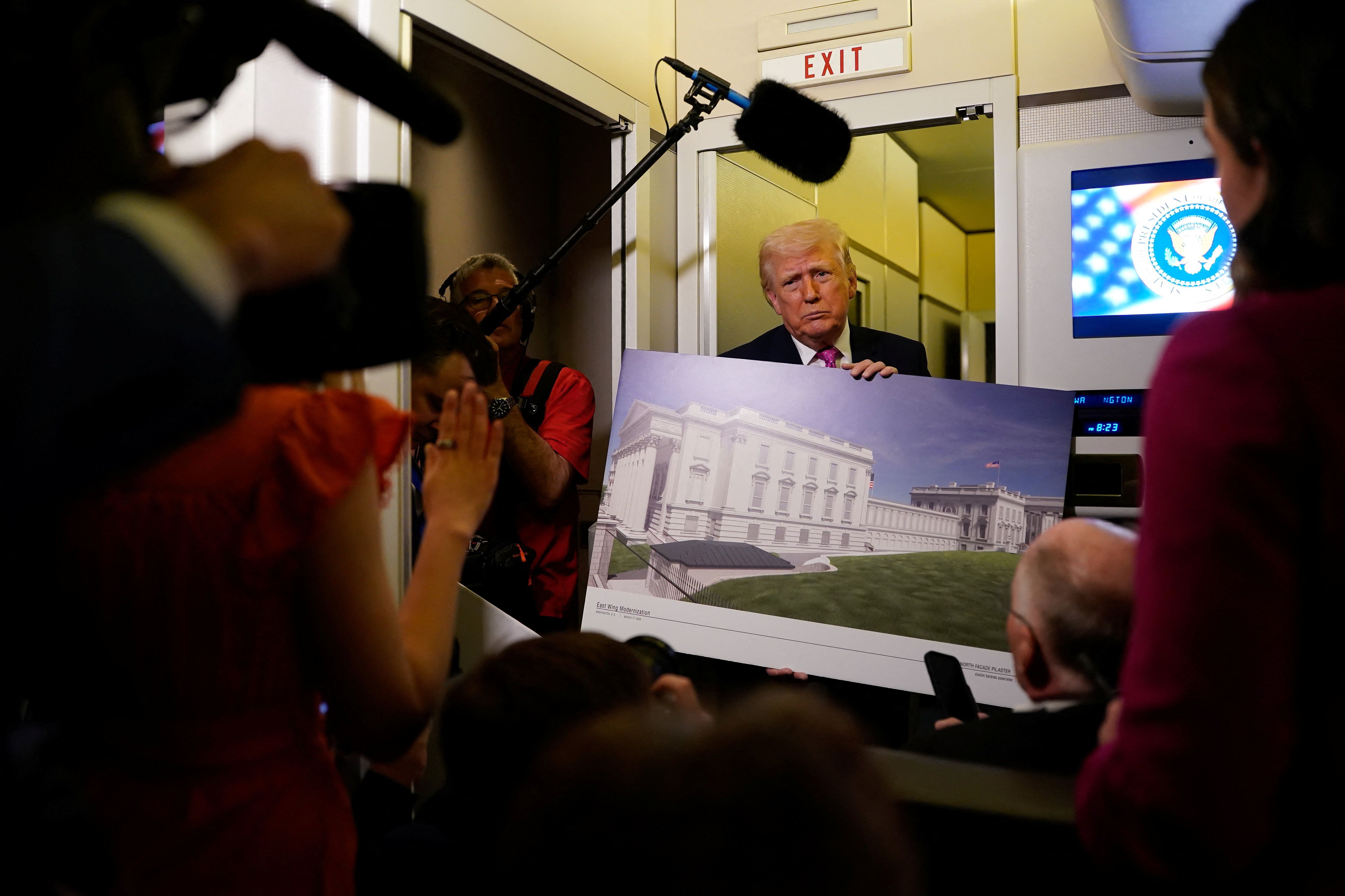 Trump holds a render of the White House ballroom
