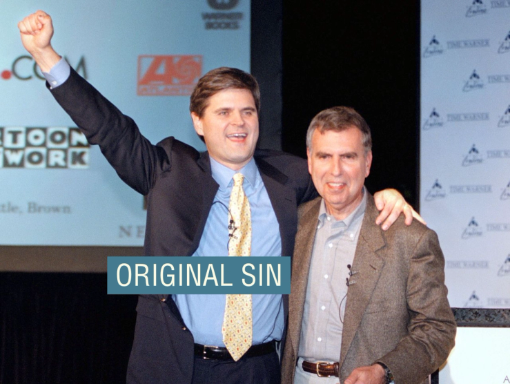 Steve Case, Chairman and CEO of America Online, left, and Gerald Levin, Chairman and CEO of Time Warner, right, hug on Monday, January 10, 2000 in New York after announcing that AOL is acquiring Time Warner.