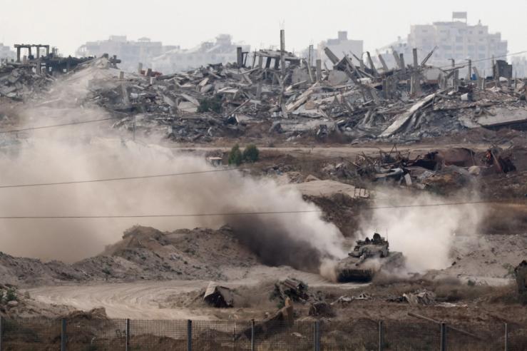 A tank manoeuvres inside Gaza, as seen from Israel, May 15, 2025.