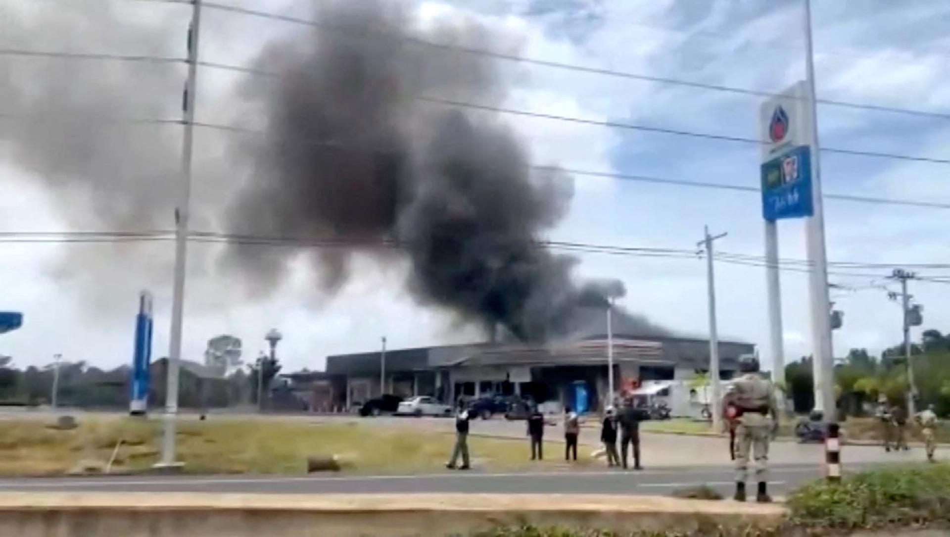 Smoke rises in Cambodia after a Thai strike. 