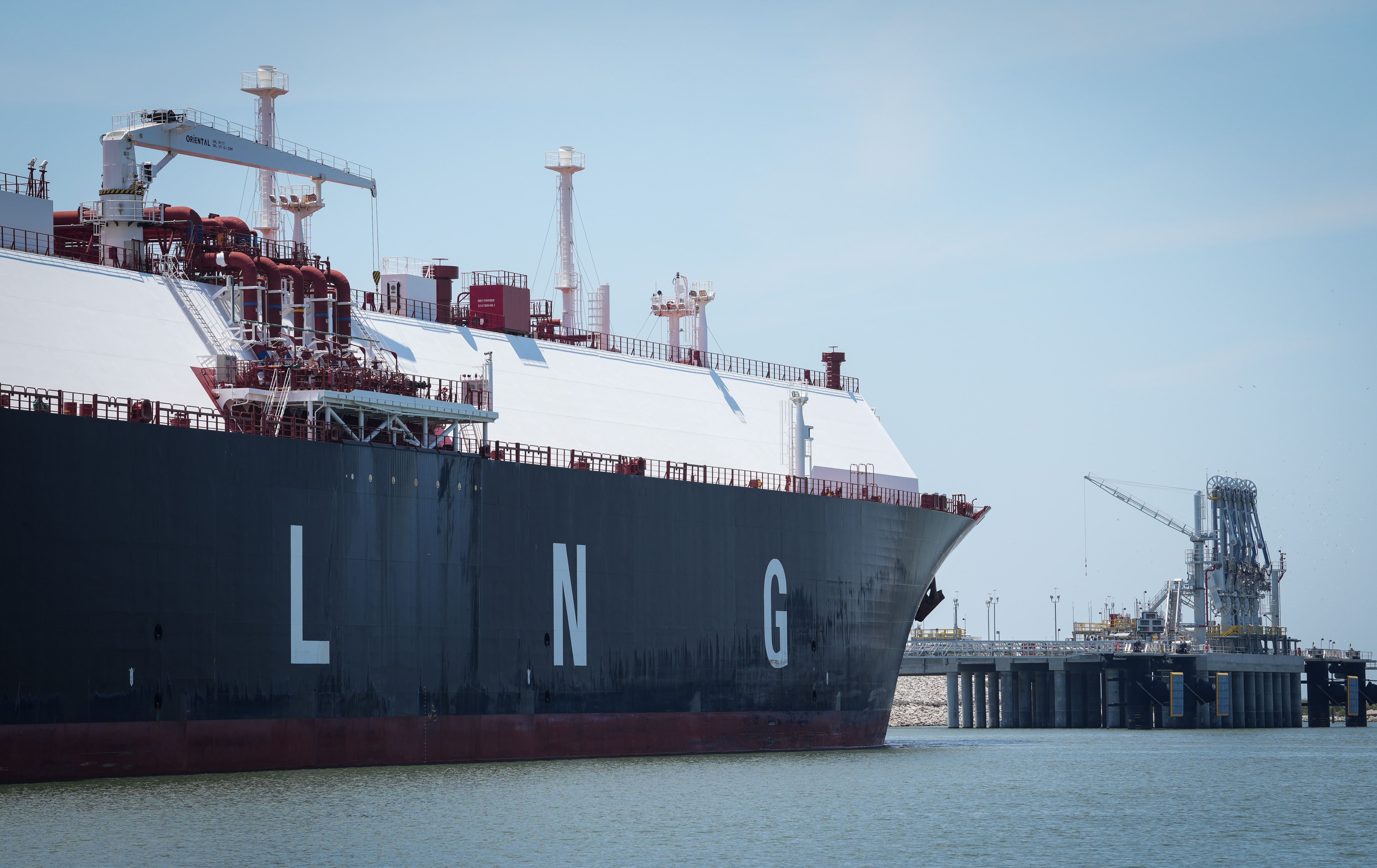 A large liquified natural gas transport ship sits docked in the Calcasieu River.