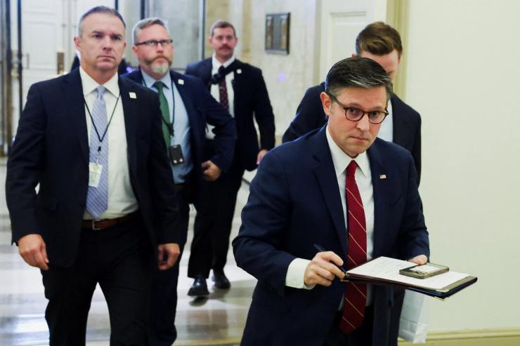 House Speaker Mike Johnson arrives at the US Capitol with his security detail.