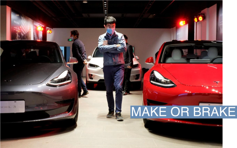 A man walks by Tesla Model 3 sedans and Tesla Model X sport utility vehicle at a new Tesla showroom in Shanghai, China May 8, 2020.