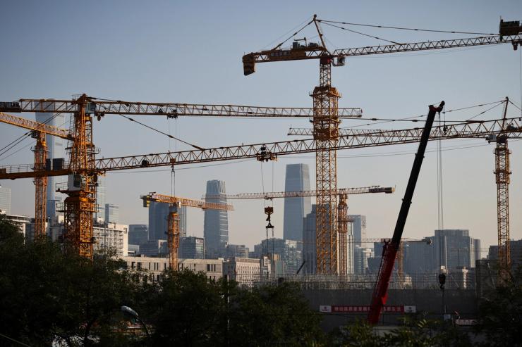 A view shows cranes in front of the skyline of the Central Business District (CBD) in Beijing.